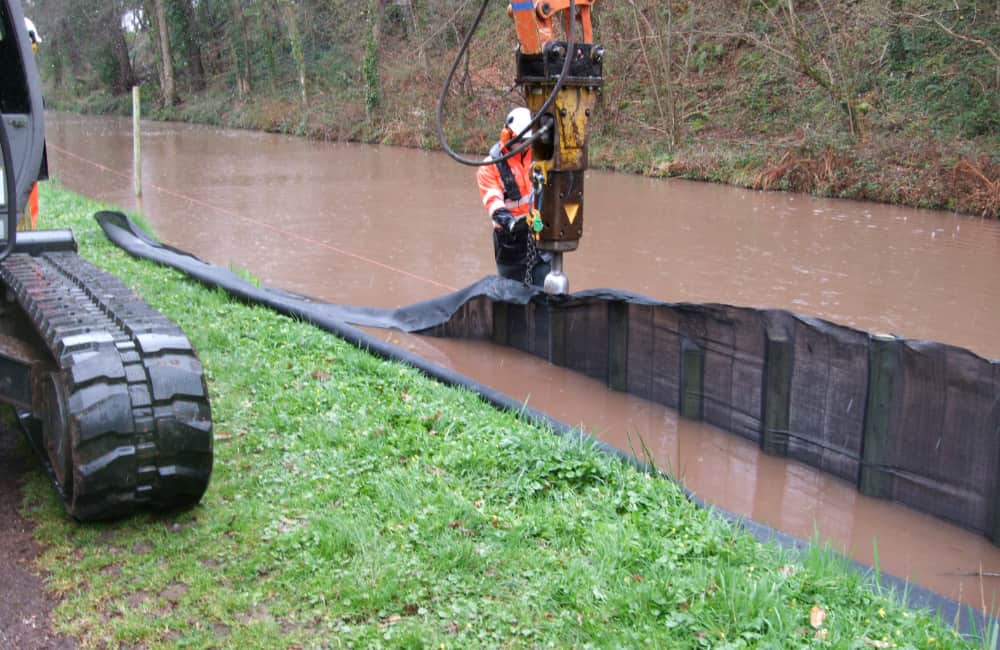 Post driven in by excavator